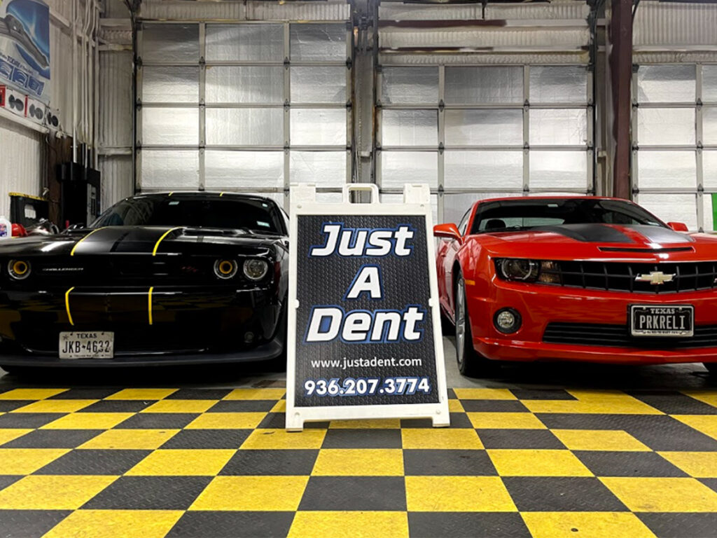 Two cars in the Just-A-Dent shop
