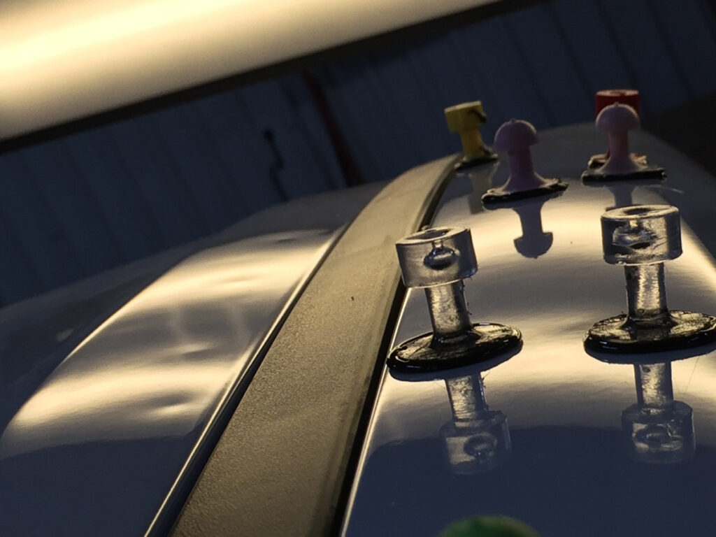 Image of suction cups attched to dents in a car
