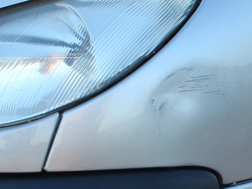 Image of a car with a small dent in it